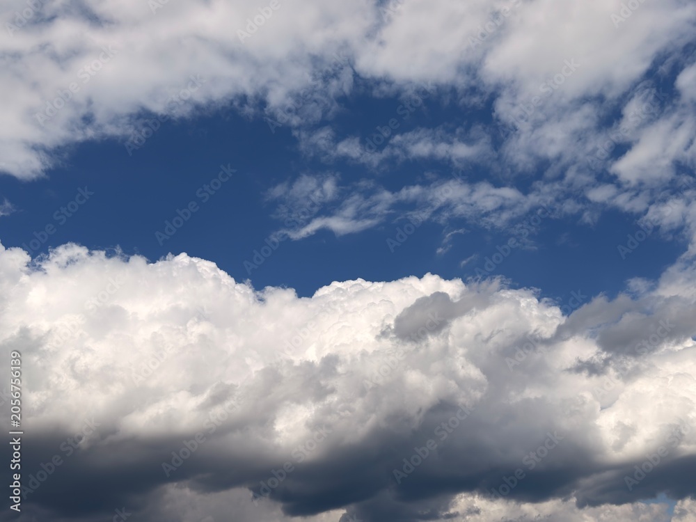 Fototapeta premium Beautiful fluffy white clouds background, sky texture for replacement or graphic design