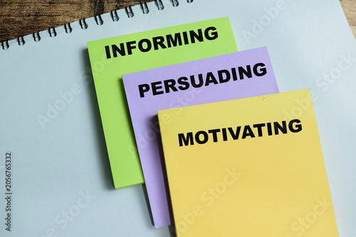 Obraz na płótnie Concept of informing, persuading and motivating write on sticky notes isolated on Wooden Table