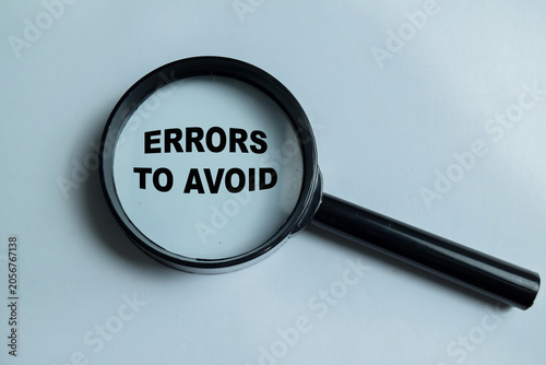 Foto Concept of errors to avoid write on book isolated on Wooden Table