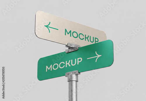 Low-angle perspective view of a metallic street signpost mockup with two directional arrows pointing left and right isolated on a solid light grey background