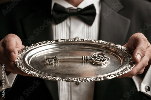 Butler offers the key to success on a silver platter at an elegant event
