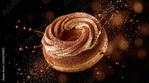 Tiramisu donut with cream swirl and cocoa powder dusting