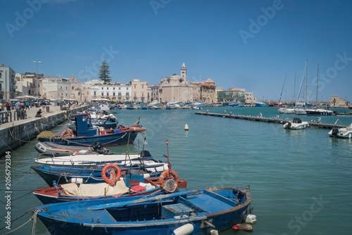Schilderij op canvas Boats from the old port and the panorama of the city of Trani; Province of Barle