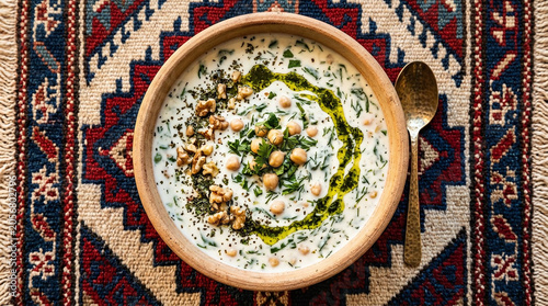 Ash mast (Kurdish yogurt soup) with walnuts and mint in earthenware bowl – traditional Iranian cuisine, creamy soup, food photography, ceramic plates, Middle Eastern, Persian cuisine