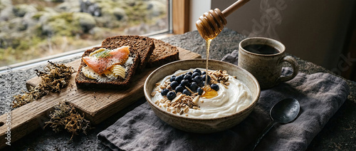 Icelandic skyr bowl with wild blueberries, honey drizzle, and dark rye rugbraud slices – healthy Nordic breakfast, food photography, commercial stock