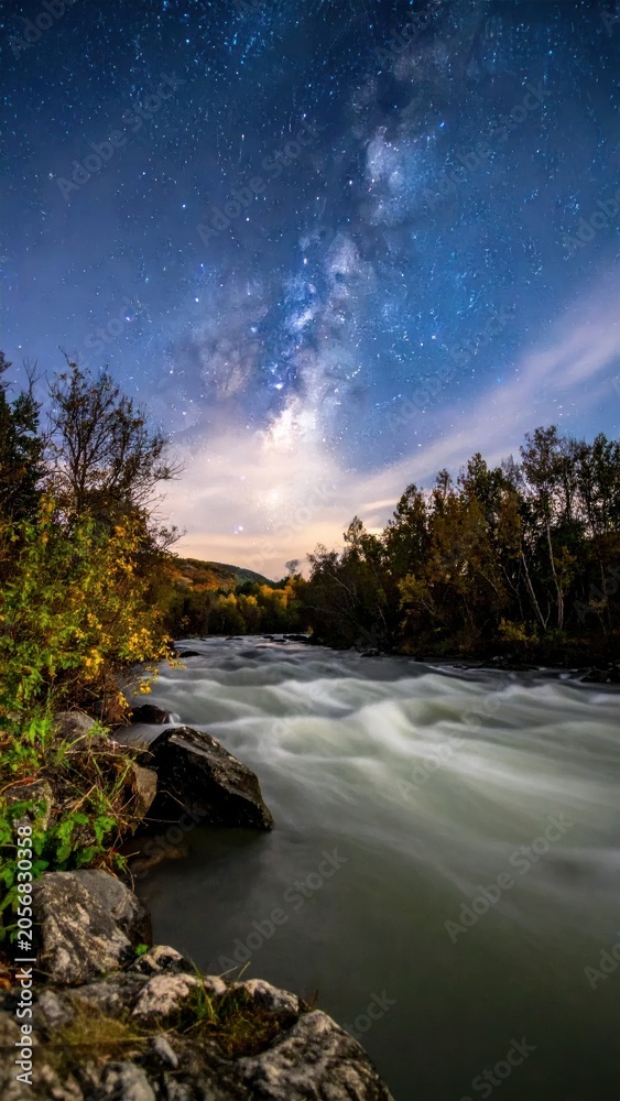Fototapeta premium Milky Way Over Rushing River at Night.