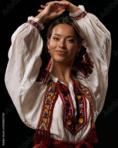 Graceful Woman in Traditional Attire Performing a Beautiful Dance, Showcasing Cultural Heritage and Poise Against a Historic Backdrop
