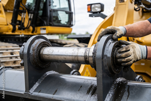фотографія Heavy machinery mechanic performing maintenance on heavy equipment joint
