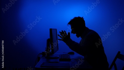 Obraz na plátne Man experiences digital frustration and anger while screaming at a desktop compu