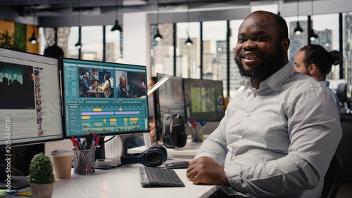 Φωτογραφία Portrait of african american man working on film montage editing, applying color grading and cutting raw clips for cinematic footage creation