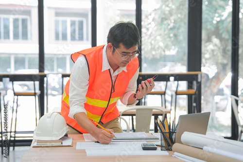 Engineer and Architect Reviewing Interior Design Plans in Office