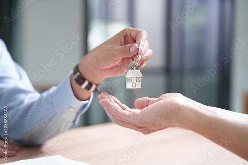 Bild auf Leinwand Key handover in real estate transaction symbolizing home ownership and investmen