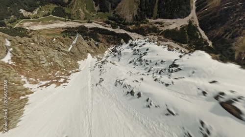 FPV sports drone fall mountain climbing peak sunny panorama speed dive over ridge alpine valley landscape. High quality 4k footage