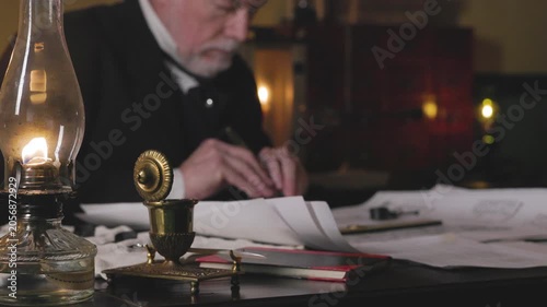 Focus on oil lamp of 1800s man using a caliper
