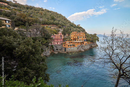 Coastal village buildings on hillside beside sea