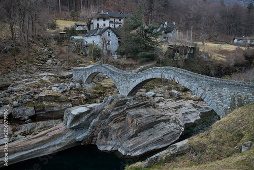 Rocky River Landscape With Distant Buildings