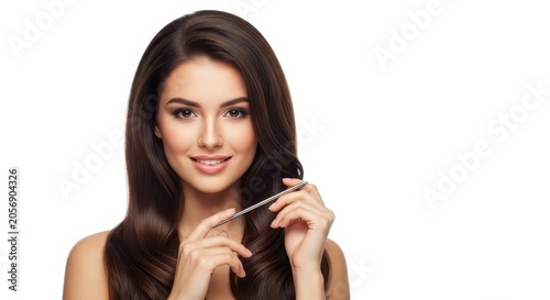 Beautiful Woman with Long Healthy Brown Hair Holding Scissors.