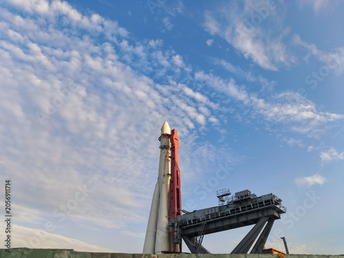 Rocket landing with platform on the launch pad on blue sky background