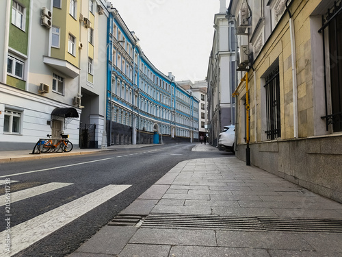 Photography Empty street with old houses in the old city center in summer sun day