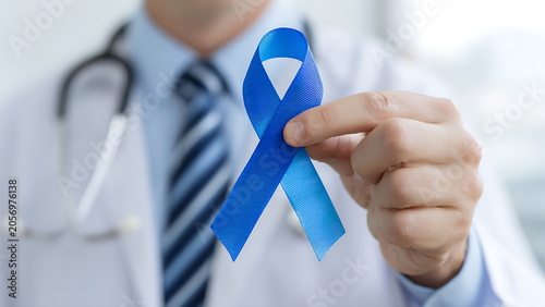  a doctor holding a blue awareness ribbon. concept of health awareness and cancer prevention campaign
