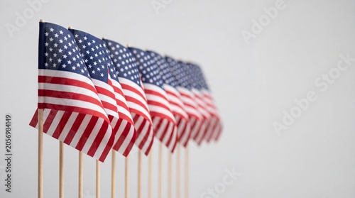 Row of small American flags on a neutral background