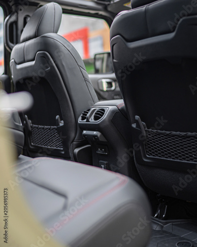 Modern car interior with leather seats and dashboard closeup.