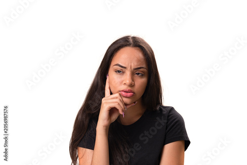 Worried young latina woman thinking with finger on cheek isolated on white background.