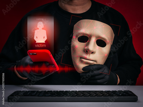 Фотография Scammer using AI deepfake technology with fake face and voice cloning through smartphone to deceive victims