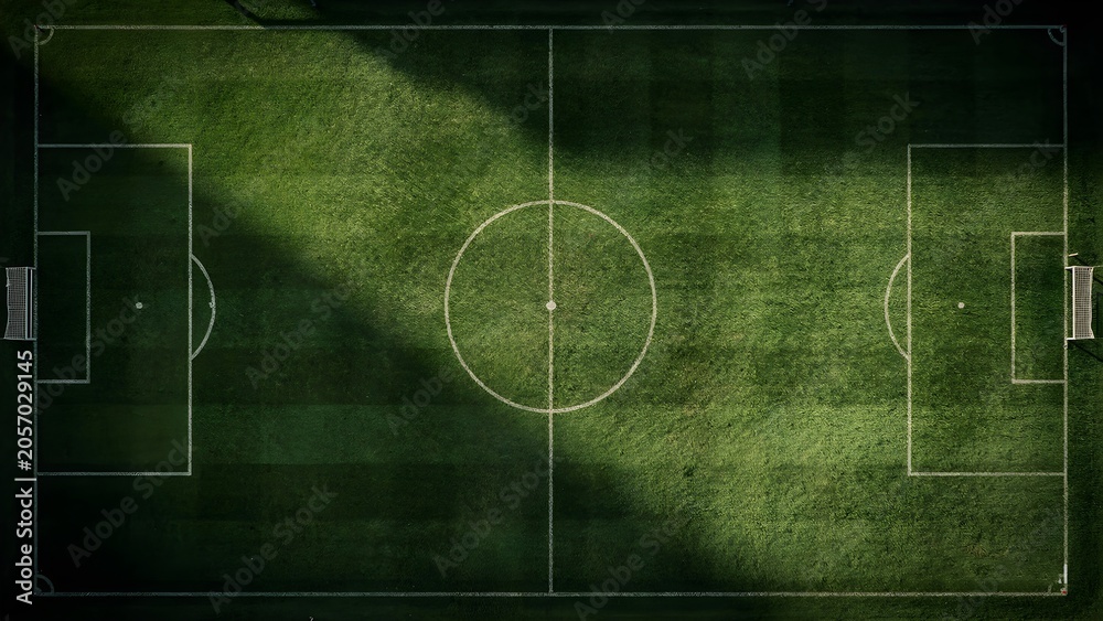 Obraz premium Aerial Top Down View of Empty Soccer Field with Dramatic Shadow and Detailed Grass Texture