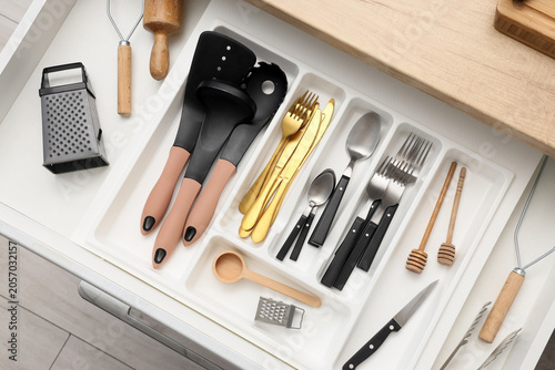Slika na platnu Organized kitchen drawer with assorted cooking utensils, cutlery, and gadgets fo