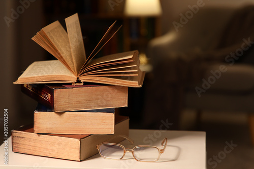Stack of old books with ope...
