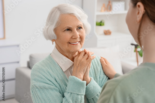 Happy senior woman with dementia and her daughter at home