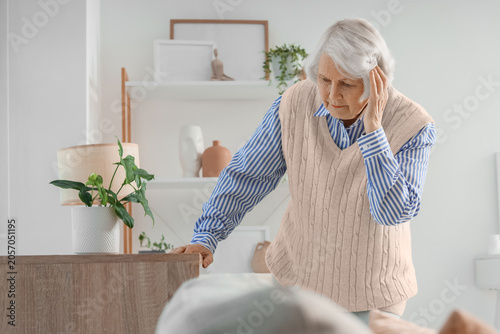 Thoughtful senior woman with dementia at home