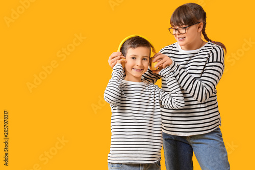 Cute girl putting headphone...