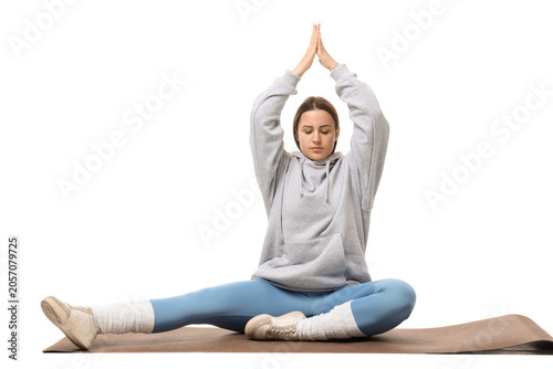 Young woman meditating on y...