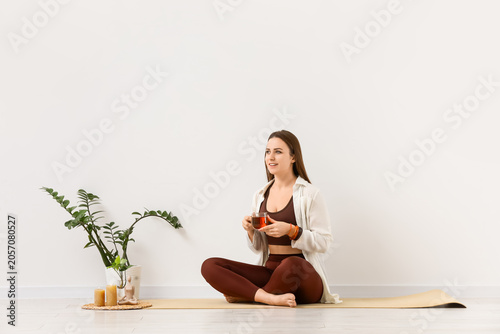 Young woman with cup of tea...