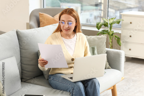 Woman in eyeglasses reviewi...