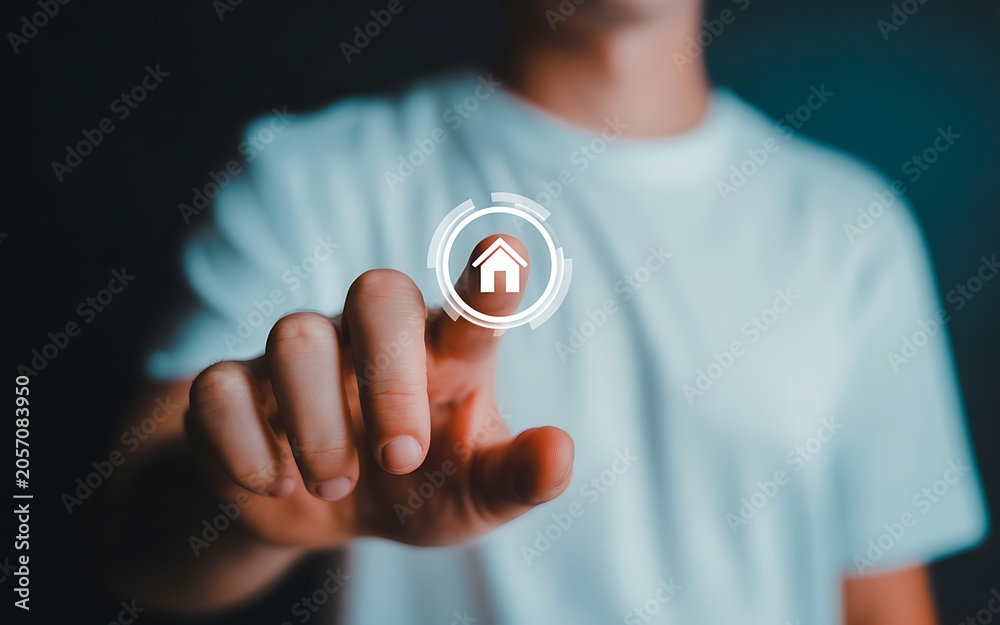 Fototapeta premium Man selecting digital home icon with finger for property search.