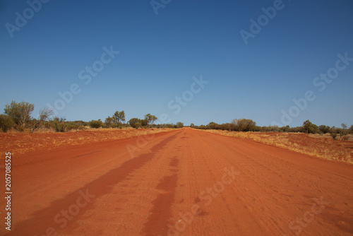 Bild auf Leinwand Empty red dirt outback road stretching to the horizon near Birdsville Track, Aus