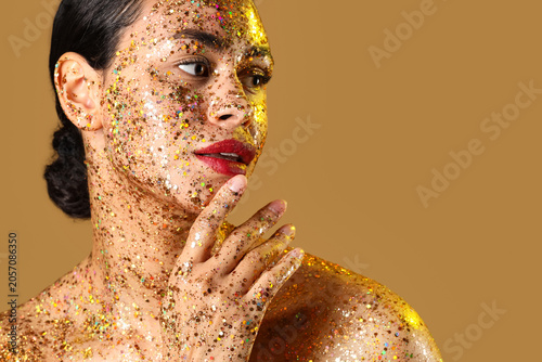 Young woman with glitter ma...