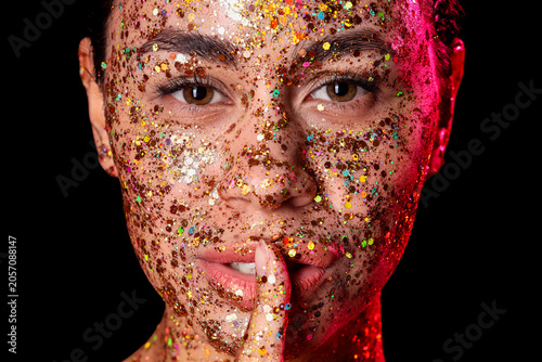 Womans face covered in glit...