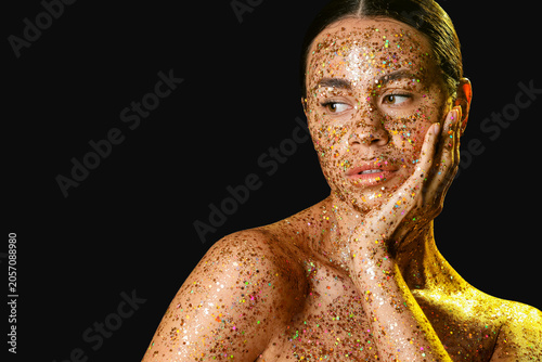 Young woman with glitter ma...
