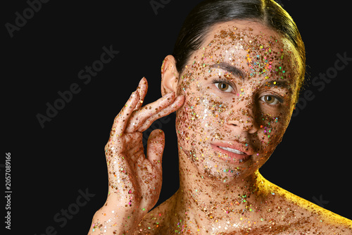 Young woman with glitter ma...