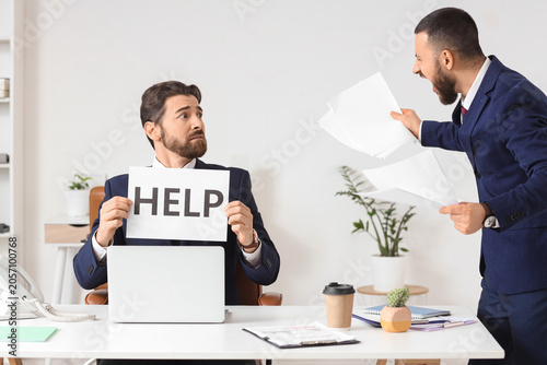 Stressed businessman holdin...