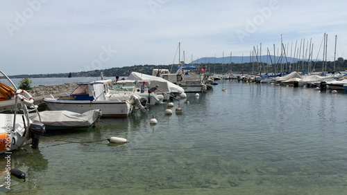 Small Motorboats and Sailboats Moored in a Calm European Harbor