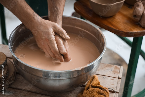 Potters hands washing clay ...