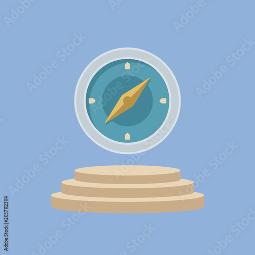 Fotografija A golden navigational compass sits atop a simple circular pedestal