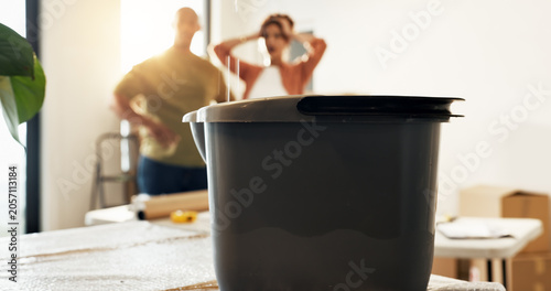 Fotografía Bucket, leaking and couple at new house with stress, roof damage and issues of unexpected repairs