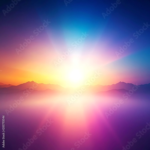 A vibrant, colorful sunrise over a foggy mountain range