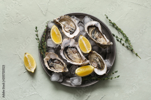 Fresh raw oysters on ice wi...